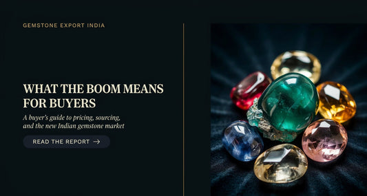 Natural gemstone rings and loose coloured stones displayed on a dark velvet surface, representing India's gemstone export boom and its impact on buyers
