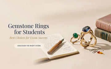 Natural emerald and yellow sapphire gold rings for students placed on an open notebook with a pen and books, representing gemstone rings for exam success