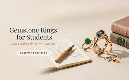 Natural emerald and yellow sapphire gold rings for students placed on an open notebook with a pen and books, representing gemstone rings for exam success
