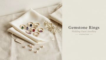 Natural gemstone rings in gold settings including ruby, emerald, blue sapphire and amethyst arranged as wedding guest jewellery options by Myra Gems