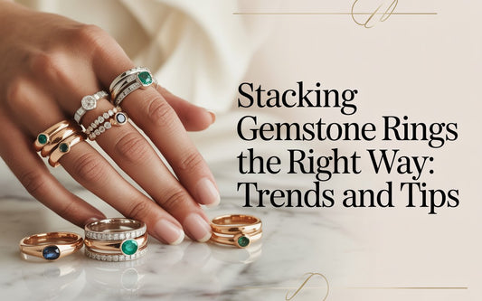 Stacking gemstone rings the right way - emerald, sapphire and diamond rings layered across fingers, with loose rings on marble surface